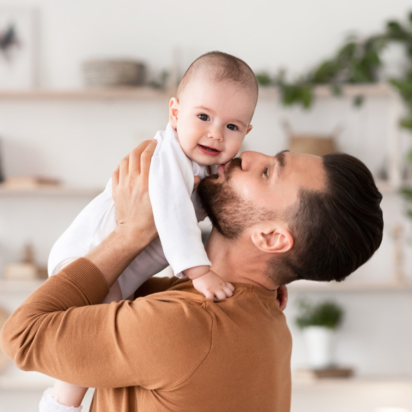 father hugging his toddler child